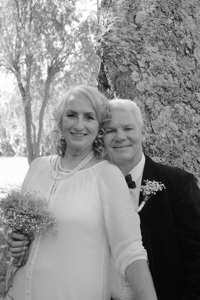 Dad and Monica in a black and white portrait by a tree