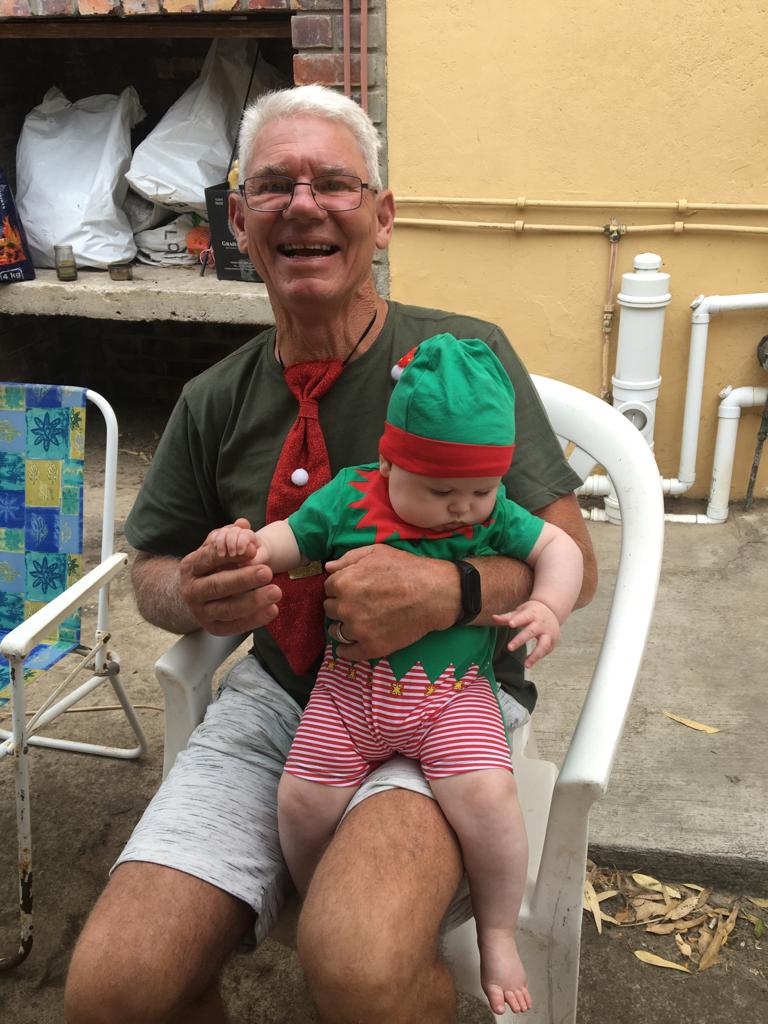 Dad holding a small child in a festive outfit