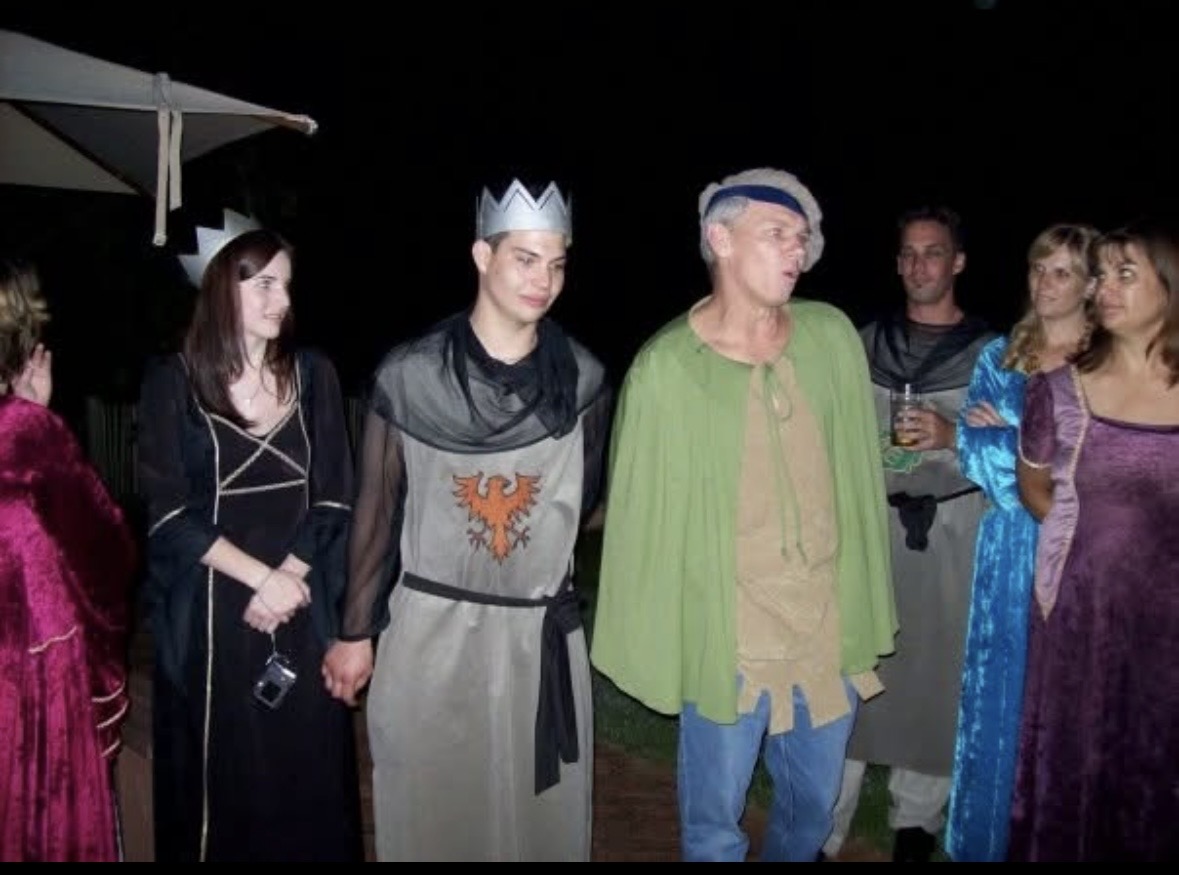 Dad and a group of people dressed for a themed evening